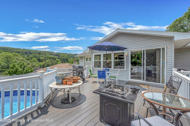 1017 Willow St Unit L14-15, Scranton, PA 18505 - deck featuring a fire pit, grilling area, and a view of trees