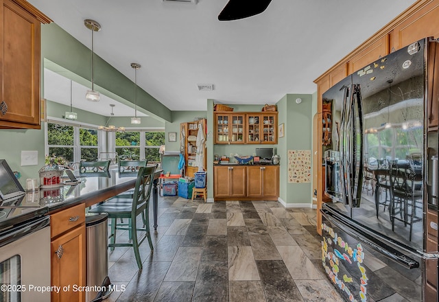 1017 Willow St Unit L14-15, Scranton, PA 18505 - kitchen with black refrigerator with ice dispenser, brown cabinets, dark countertops, and stone tile flooring