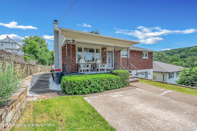 1017 Willow St Unit L14-15, Scranton, PA 18505 - view of front facade with a porch, brick siding, and a chimney