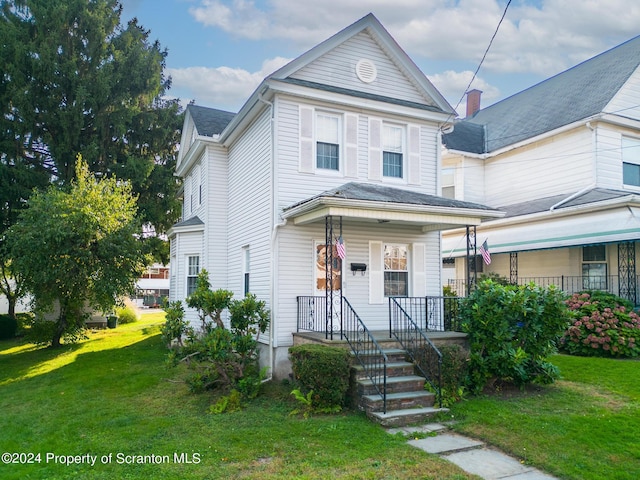 view of front of home with a porch and a front yard