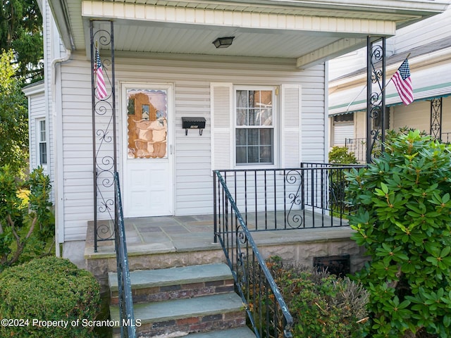 doorway to property featuring covered porch