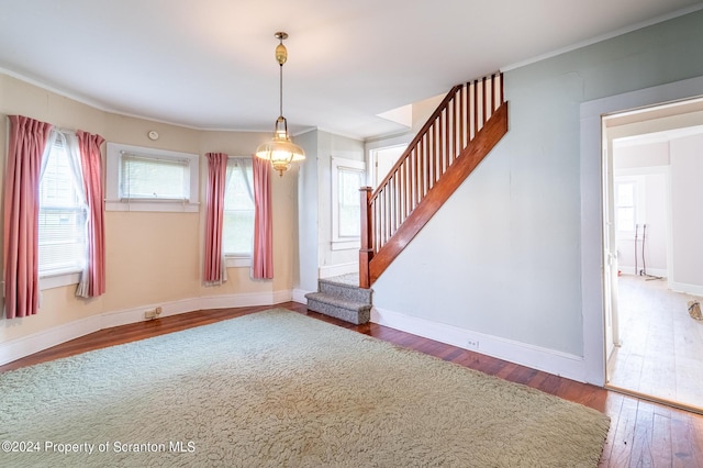 unfurnished room featuring hardwood / wood-style flooring and ornamental molding