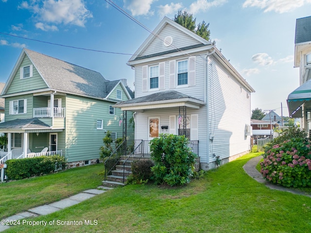 view of property featuring a porch and a front yard