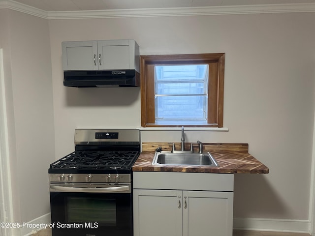 kitchen with sink, white cabinetry, crown molding, and stainless steel range with gas stovetop