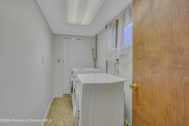 clothes washing area featuring washer and dryer