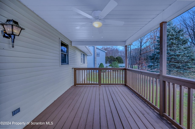 wooden deck featuring ceiling fan