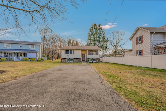 raised ranch featuring a front lawn