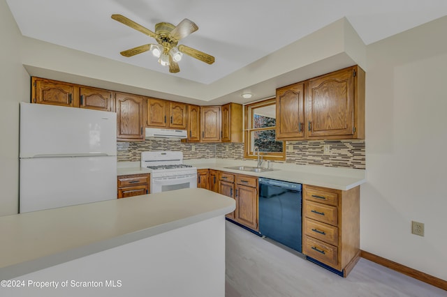 kitchen with decorative backsplash, white appliances, ceiling fan, and sink