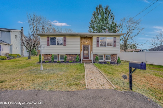 bi-level home with a front lawn