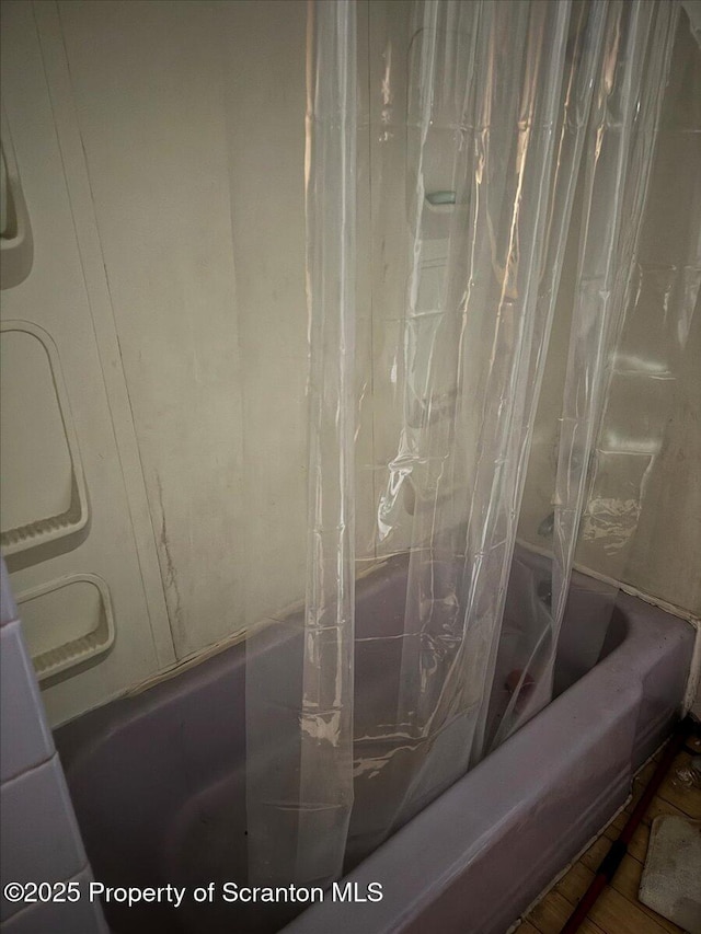 interior details featuring shower / bath combo with shower curtain