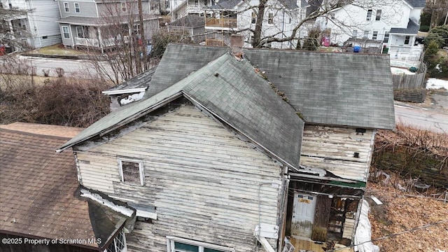 view of side of home featuring a shingled roof