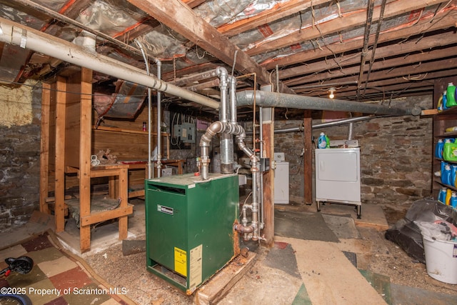 unfinished basement with washer / dryer and a heating unit