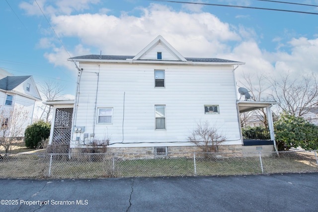 view of side of home with a fenced front yard