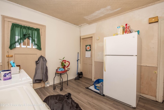 laundry room with laundry area, wood finished floors, and a textured ceiling