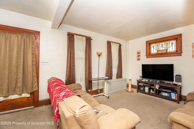 carpeted living room featuring beamed ceiling, baseboards, and radiator heating unit