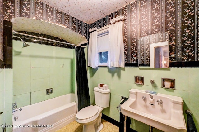 full bathroom with tile walls, sink, shower / bath combination with curtain, and toilet