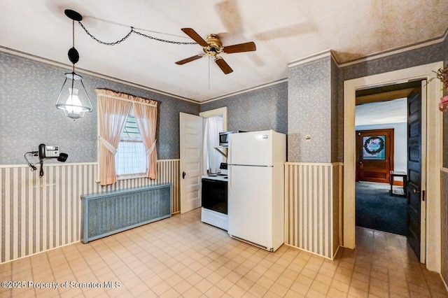 kitchen featuring electric stove, crown molding, hanging light fixtures, radiator heating unit, and white refrigerator