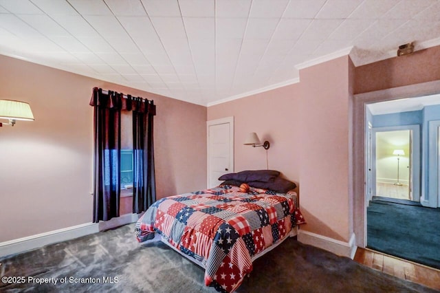 bedroom featuring crown molding and carpet