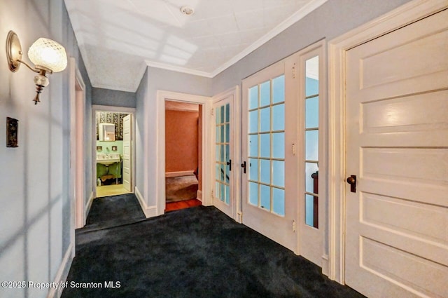 carpeted entryway with crown molding and french doors