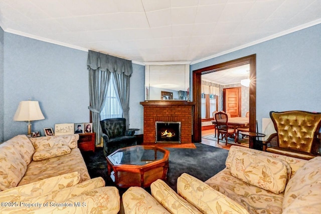 living room with a brick fireplace, ornamental molding, and hardwood / wood-style floors