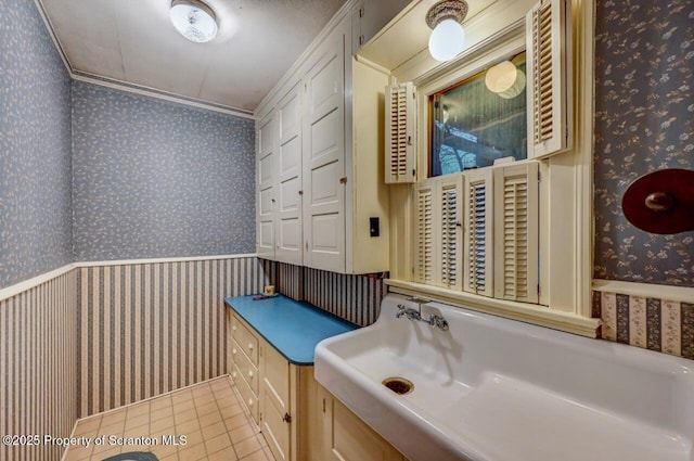 bathroom with ornamental molding and tile patterned floors