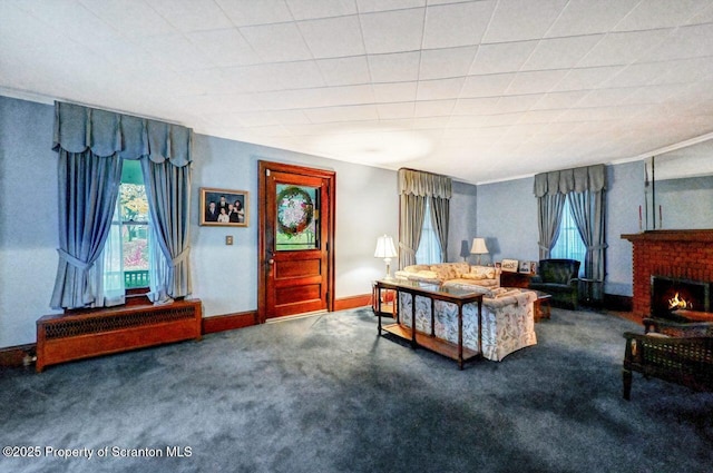 living room with a brick fireplace and carpet floors