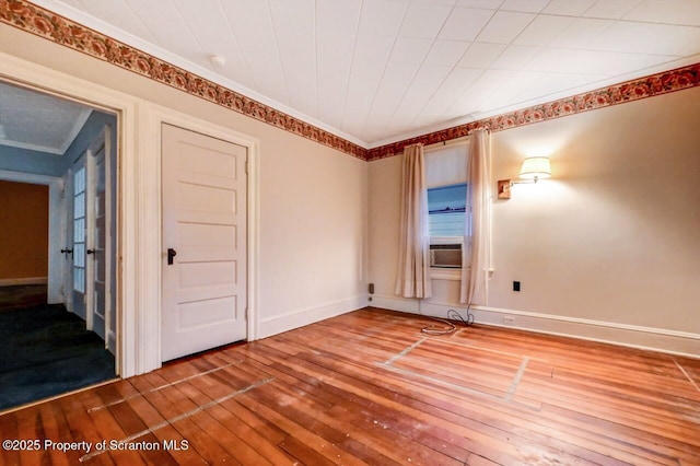 spare room with hardwood / wood-style flooring and cooling unit