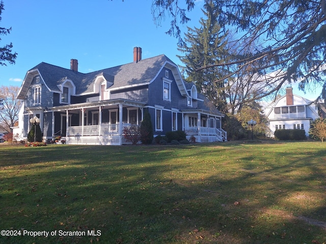 view of home's exterior featuring a porch, a yard, and a sunroom