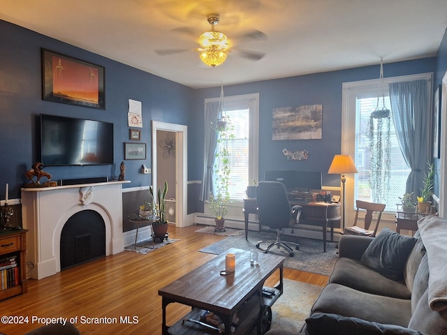 living room featuring ceiling fan, hardwood / wood-style floors, and a healthy amount of sunlight