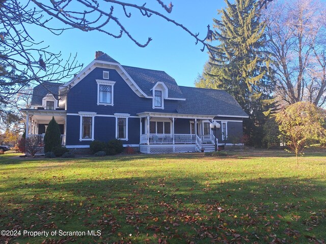 view of front facade with covered porch and a front lawn