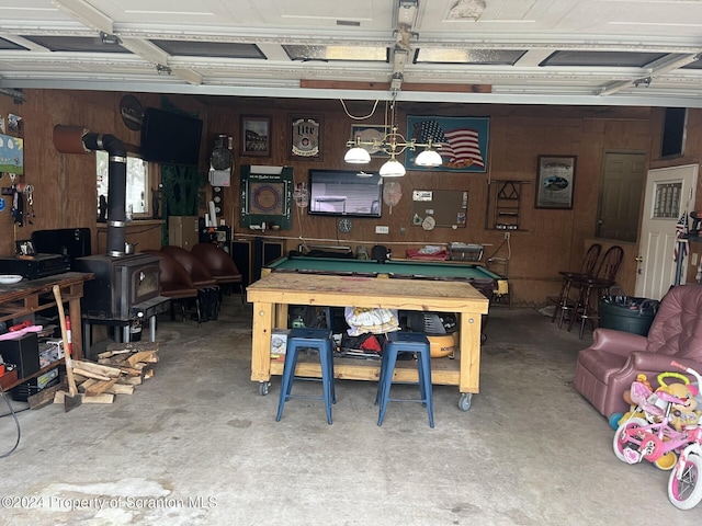 playroom with a chandelier, concrete floors, pool table, and wood walls