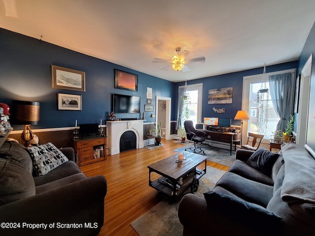 living room featuring ceiling fan and hardwood / wood-style flooring