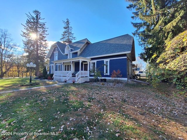 view of front of house with a front yard and a porch