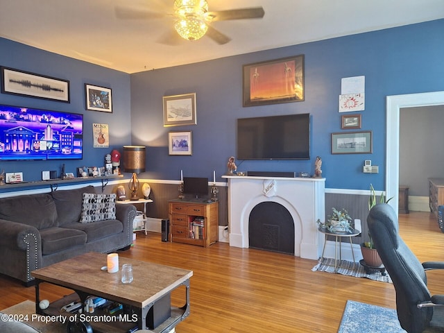 living room featuring ceiling fan and light wood-type flooring