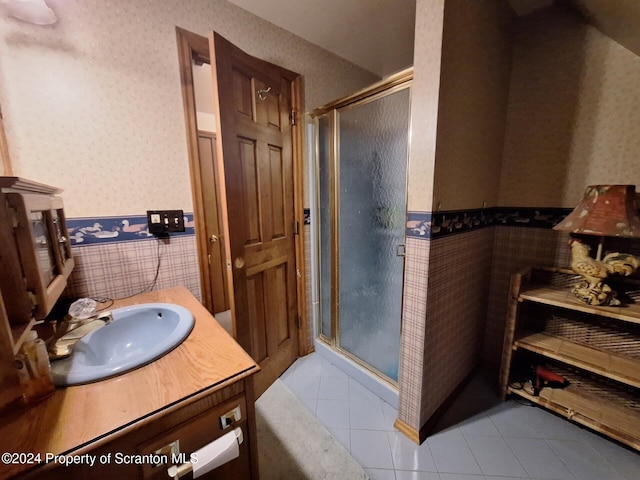 bathroom with tile patterned flooring, vanity, and a shower with shower door