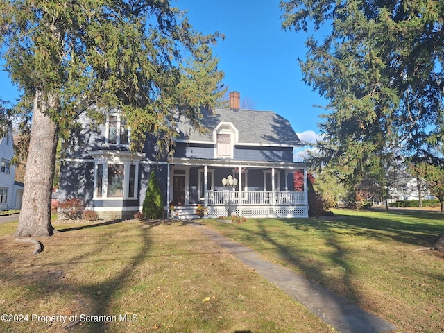 view of front of house with covered porch and a front yard