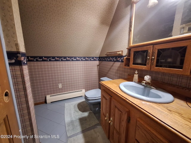 bathroom with tile patterned flooring, vanity, toilet, and baseboard heating