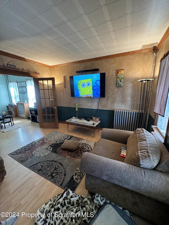 living room with hardwood / wood-style floors and ornamental molding