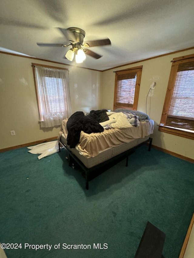 carpeted bedroom with ceiling fan and crown molding