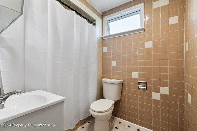 bathroom featuring curtained shower, sink, tile walls, and toilet