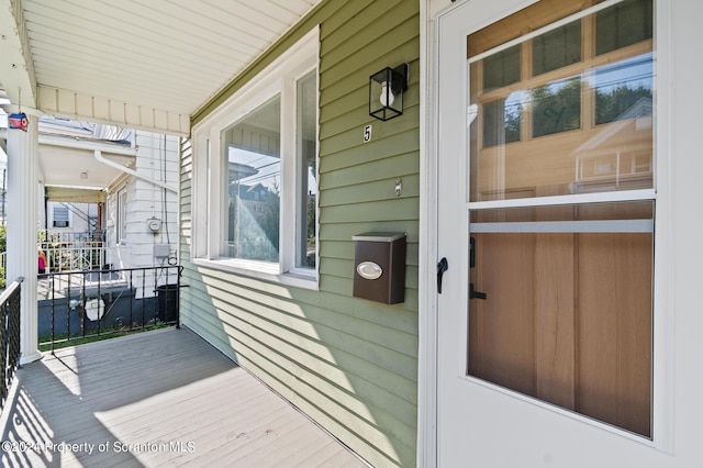 wooden terrace featuring covered porch