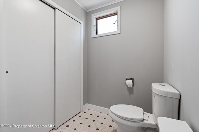 bathroom featuring toilet and ornamental molding