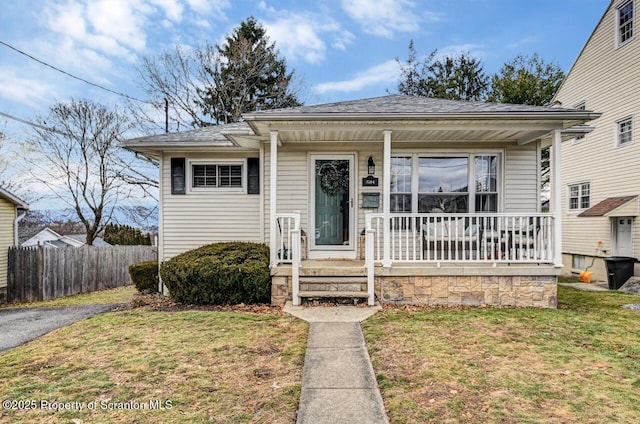 bungalow-style house with a porch and a front lawn