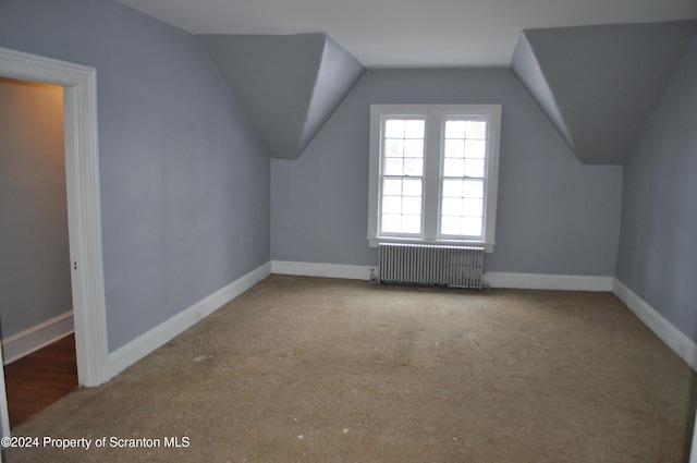 bonus room with carpet flooring, radiator heating unit, and lofted ceiling