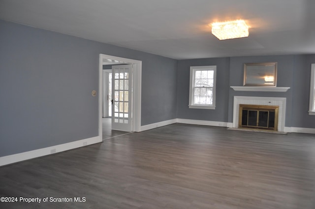 unfurnished living room featuring dark hardwood / wood-style floors