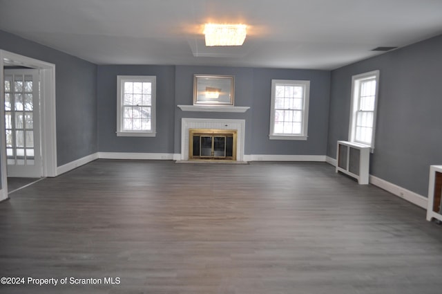 unfurnished living room featuring dark hardwood / wood-style flooring