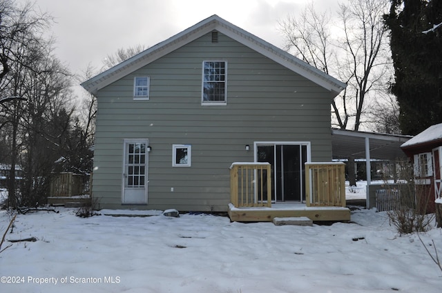 snow covered property featuring a deck