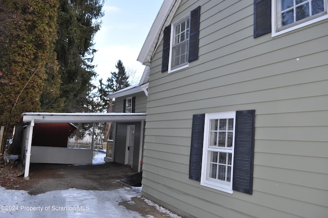 view of home's exterior with a carport