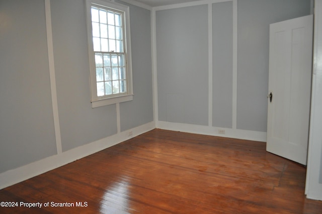 spare room with dark hardwood / wood-style flooring