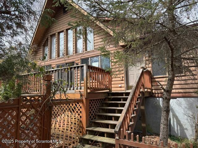 166 Tanglewod Dr, Greentown, PA 18426 - back of property with stairway and a wooden deck